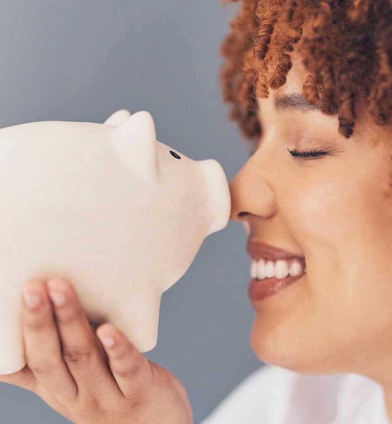 Women smiling at piggy bank